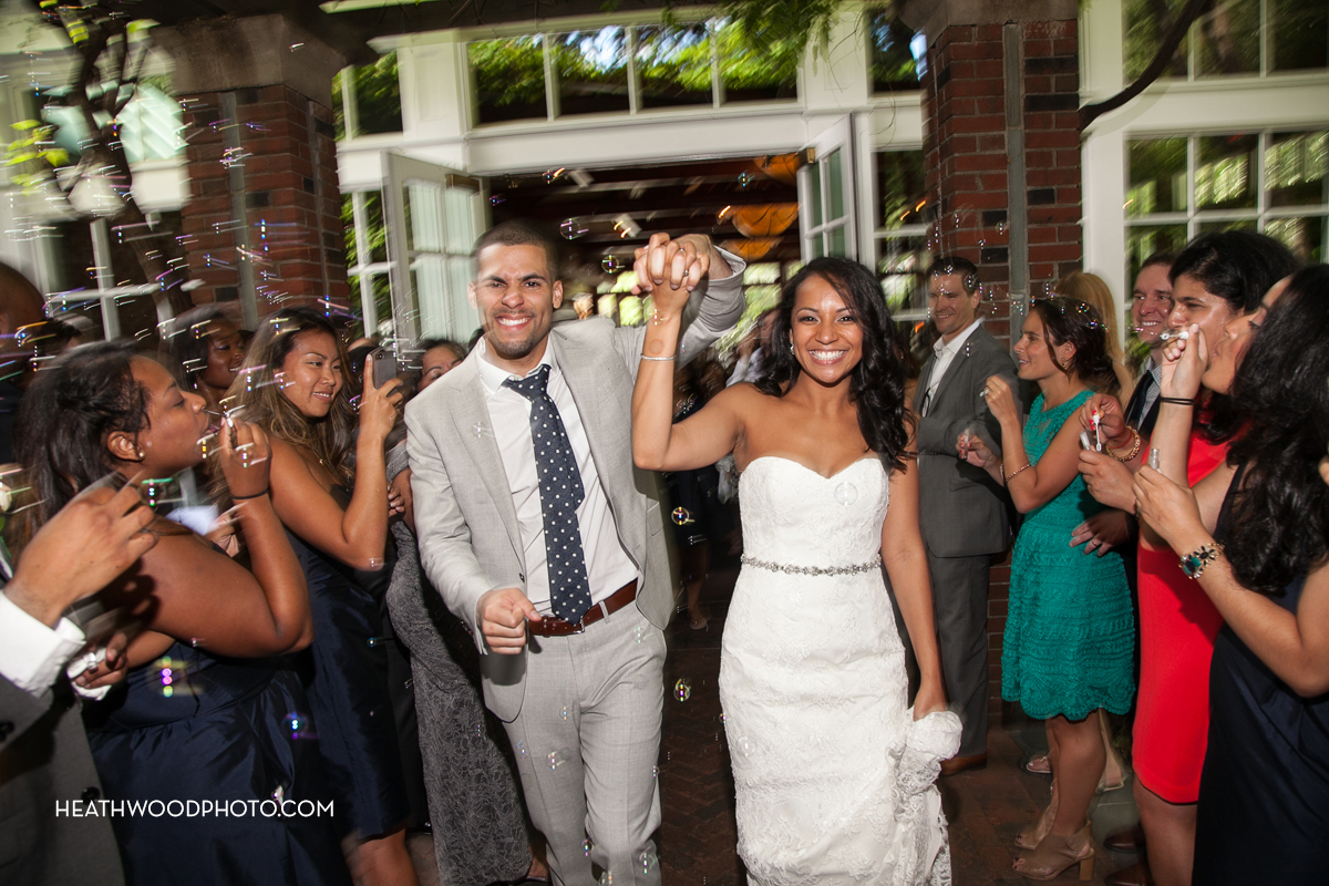 Bride and Groom grand exit through guests blowing bubbles by: Heathwood Photo