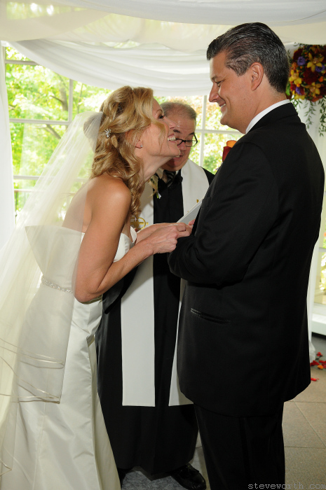 Close up of Laura laughing during the ceremony by: Kira Yustak
