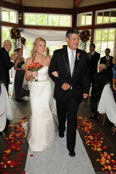 Laura and Peter walk back up the aisle after the ceremony by: Kira Yustak