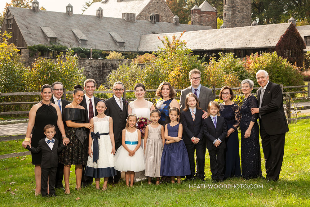 Family portrait in farm field, barns in background by: Heathwood Photo