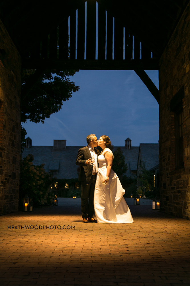 Bride and Groom in barn courtyard at night by: Heathwood Photo