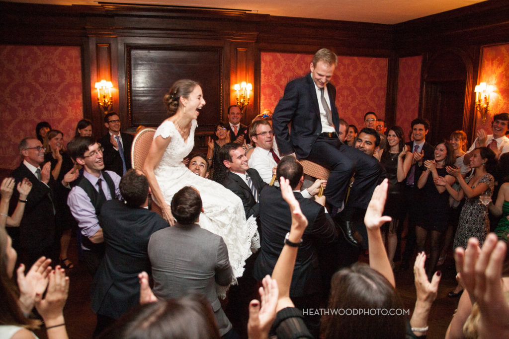 Bride and Groom lifted up during hora dance by: Heathwood Photo