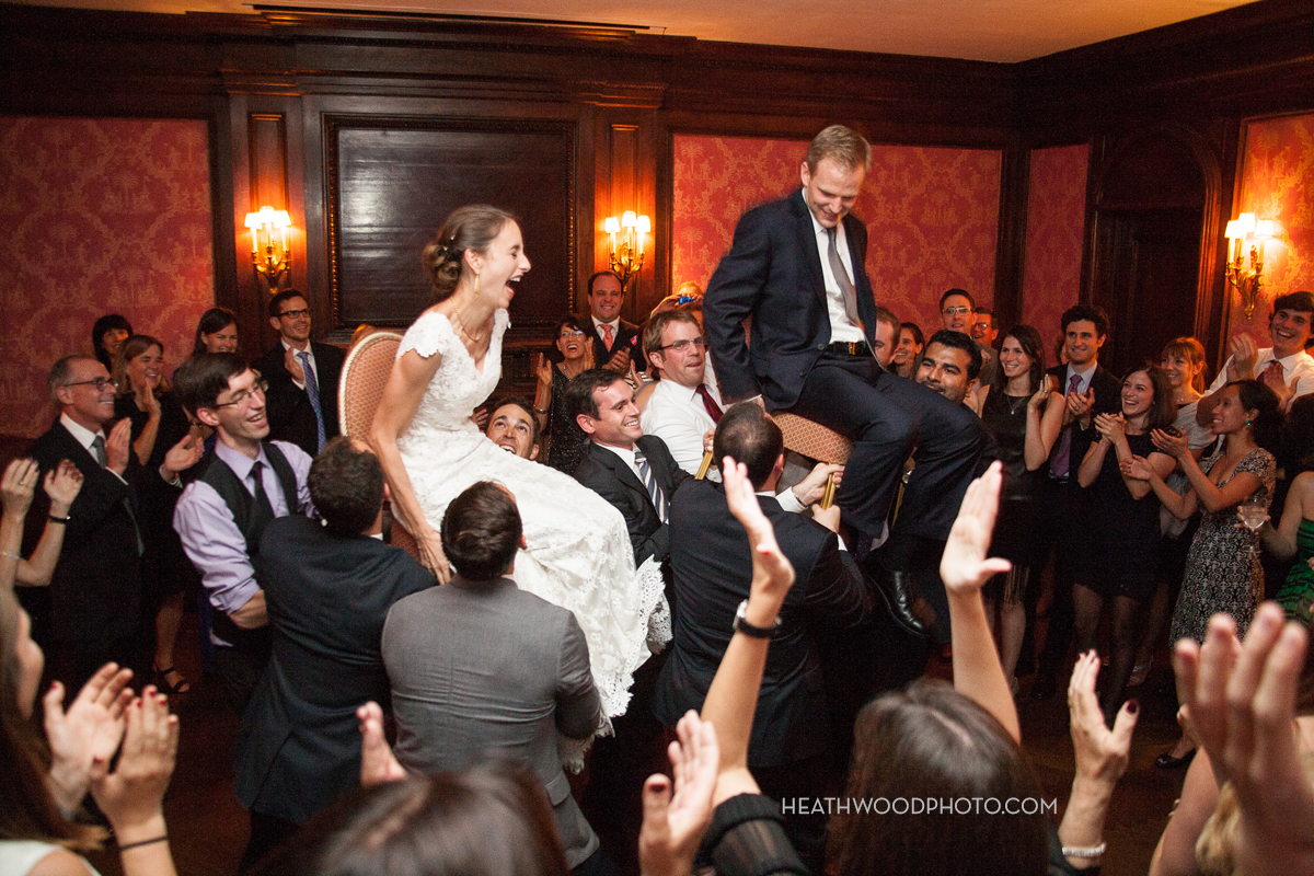 Bride and Groom lifted up during hora dance by: Heathwood Photo