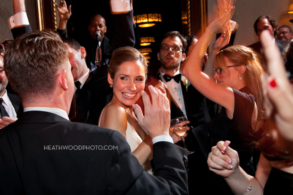 Bride dancing on crowded dance floor by: Heathwood Photo