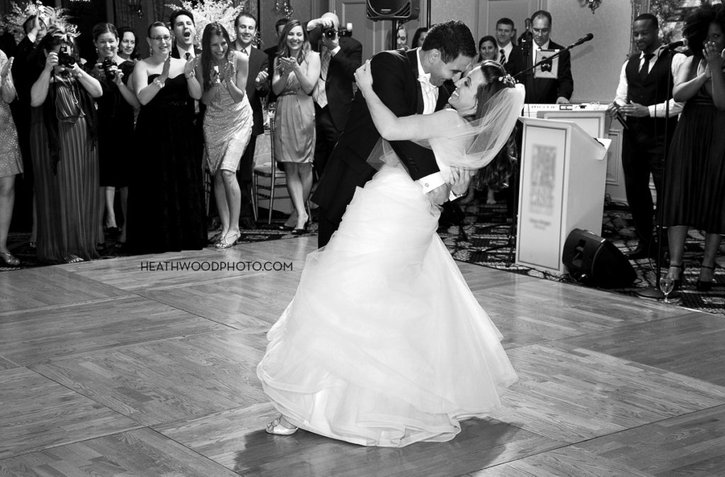 Groom dips bride during first dance by: Heathwood Photo