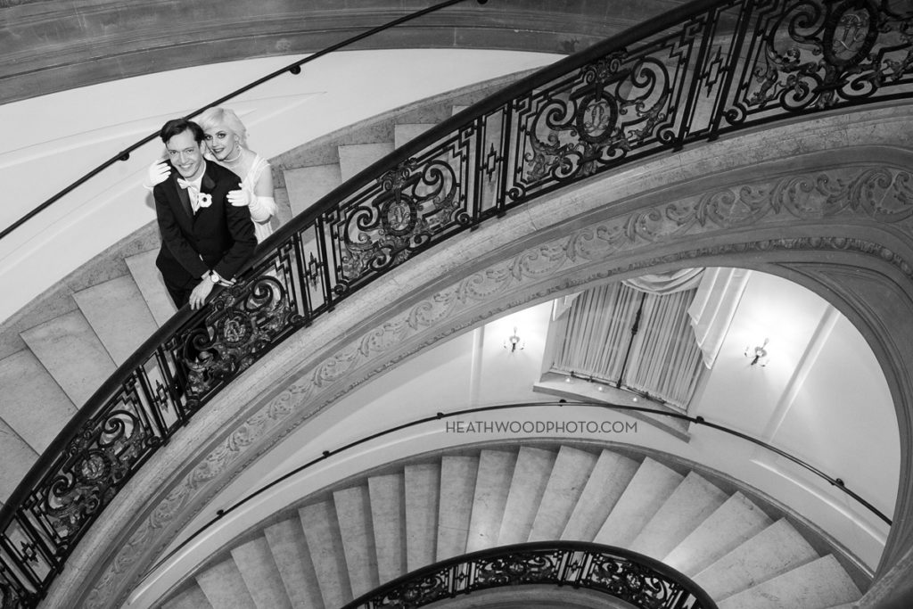 Bride and Groom on grand oval staircase by: Heathwood Photo