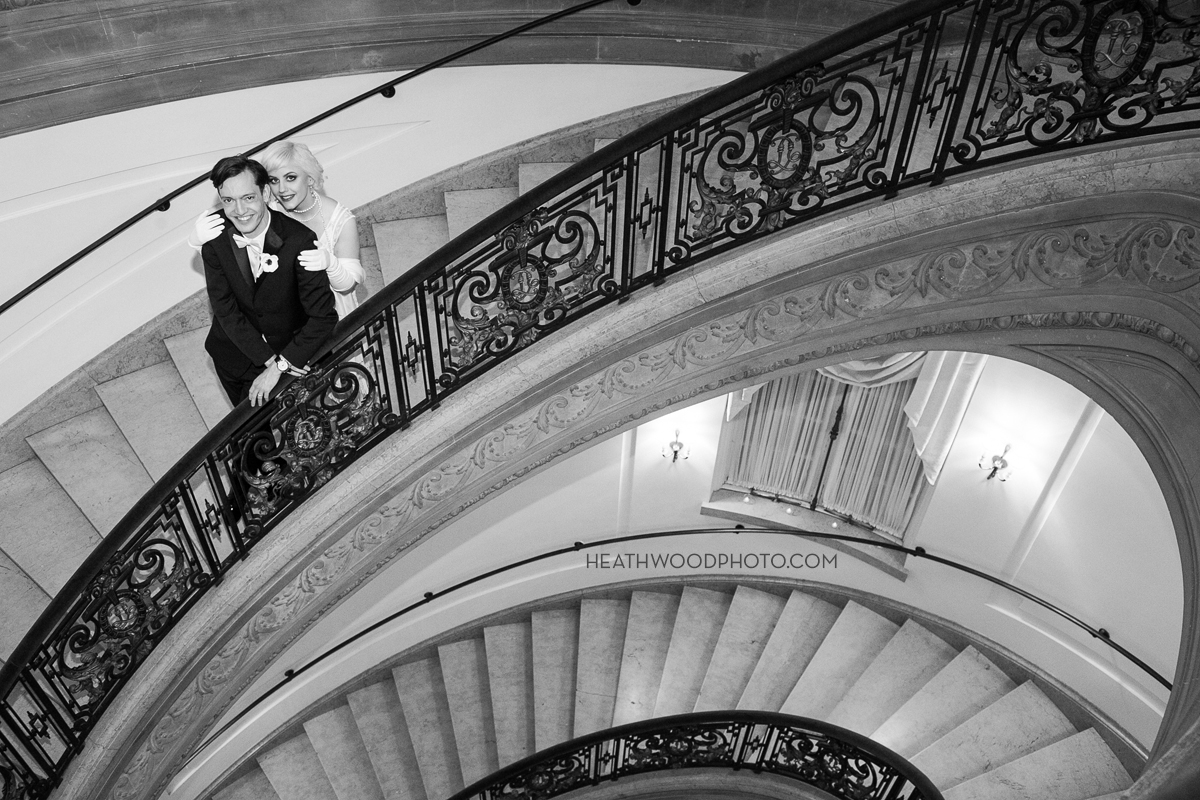 Bride and Groom on grand oval staircase by: Heathwood Photo