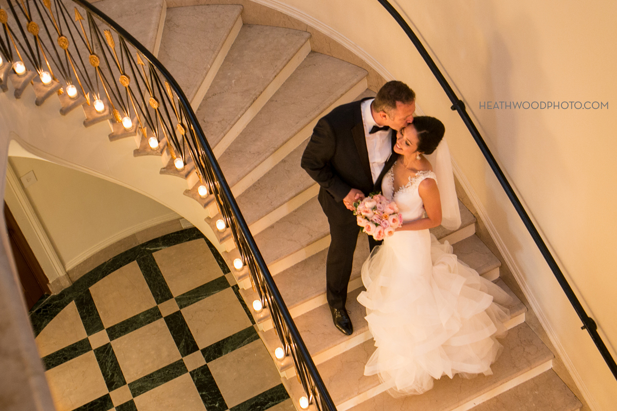 Looking down staircase at bride and groom by: Heathwood Photo