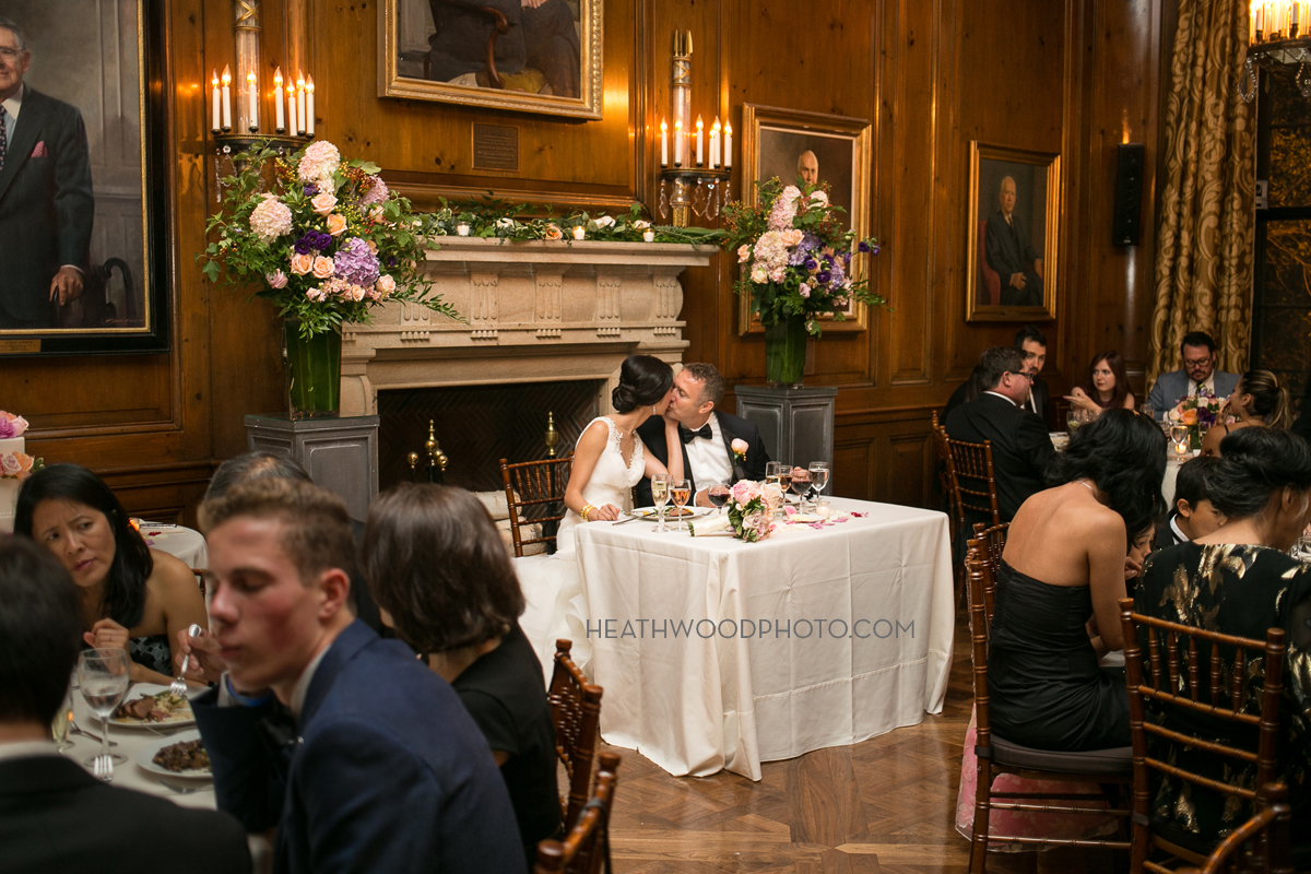 Bride and groom at sweetheart table in dining room at reception by: Heathwood Photo