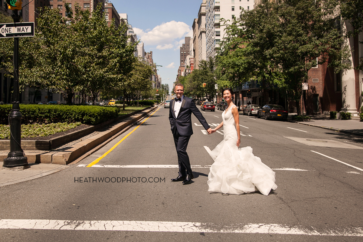 Bride and groom cross Park Ave. just outside Harold Pratt House by: Heathwood Photo