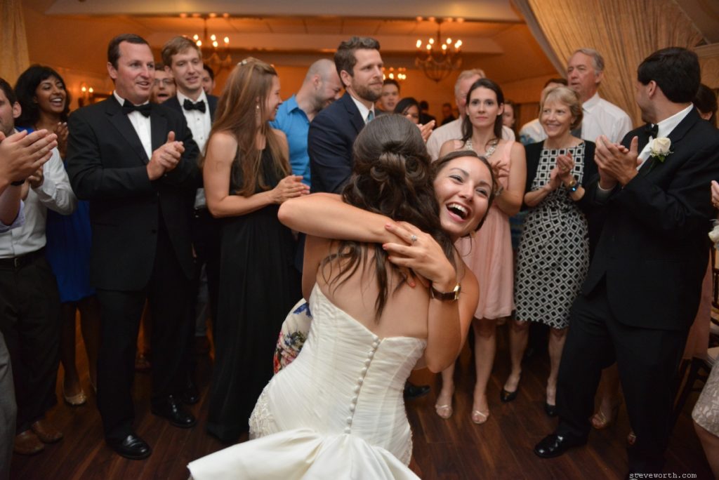 Friend Hugging Bride on Dancefloor by: Steve Worth Photography