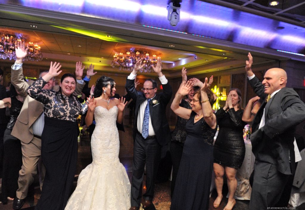 Bride and Groom dancing with Hands in the Air by: Kira Yustak