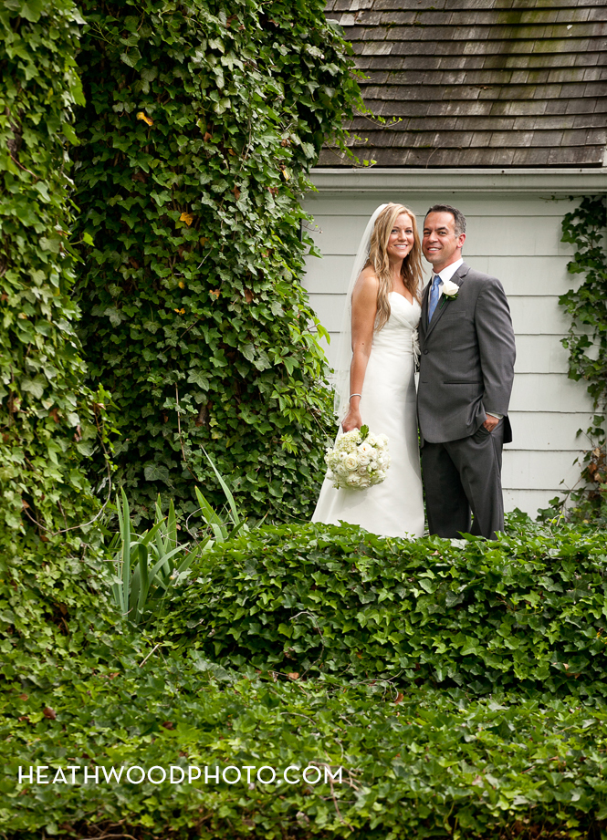 Bride and Groom pose in front of Inn by: Heathwood Photo
