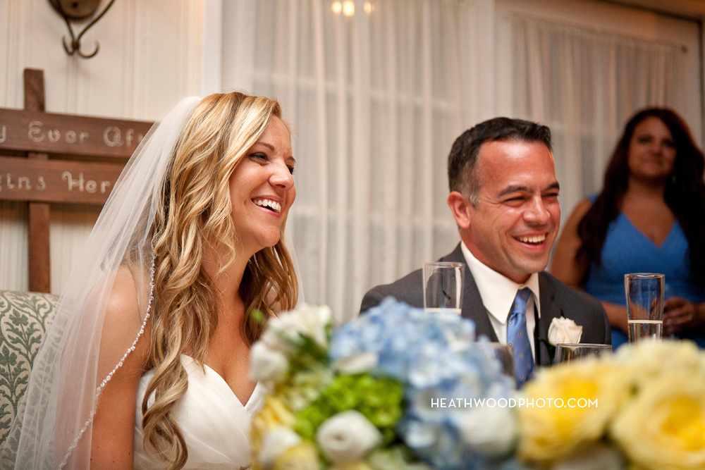 Bride and Groom listen and laugh by: Heathwood Photo