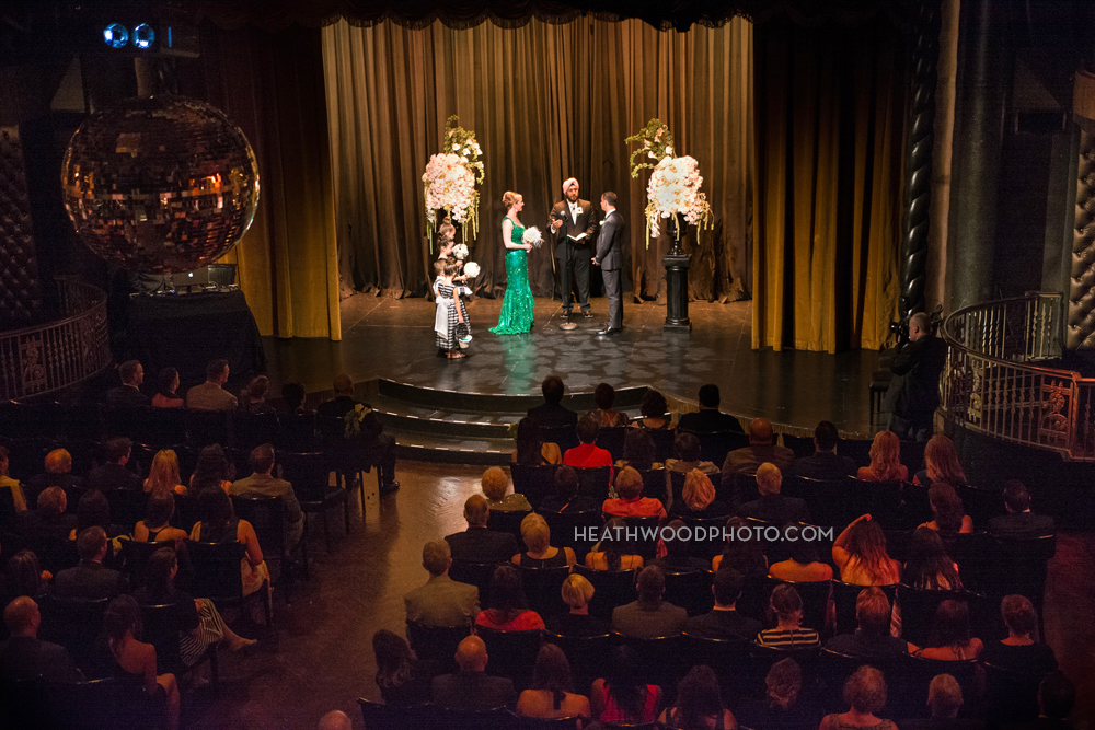 Wedding ceremony on retro nightclub stage by: Heathwood Photo