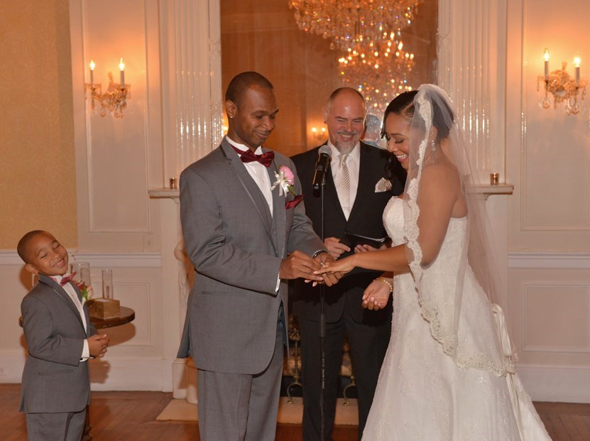 Groom putting on the Ring by: Steve Worth Photography